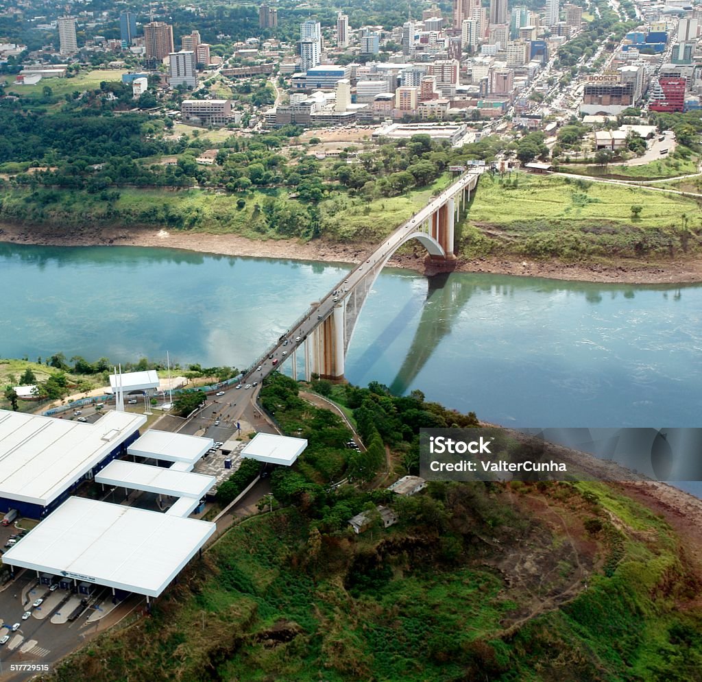 International Friendship Bridge between Brazil, Paraguay, Argentina Aerial view of the International Friendship Bridge connecting Brazil, through the state of Paraná, to Argentina and Paraguay, in South America, through the border cities: Foz do Iguaçu (Brazil), Puerto Iguazú (Argentina) and Ciudad del Leste (Paraguay). It is there that is one of the Seven Wonders of the World, the Falls of Foz do Iguaçu, with access by the Argentine and Brazilian sides. The bridge was inaugurated in 1965. Paraguay Stock Photo