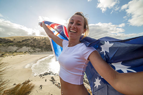 istock Cheering woman on beach holding Australian's flag 517738132