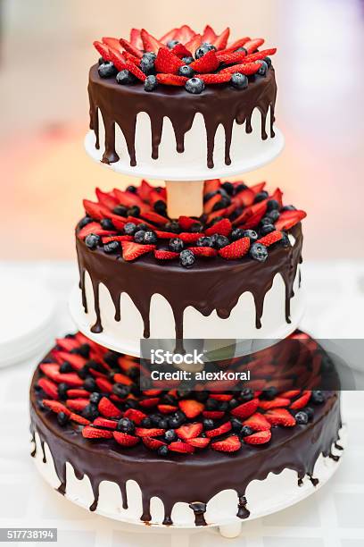 Wedding Cake With Strawberries And Blueberries In Chocolate Glaze Stock Photo - Download Image Now