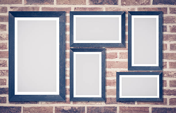 istock Wooden picture frame on brick wall background 517739332