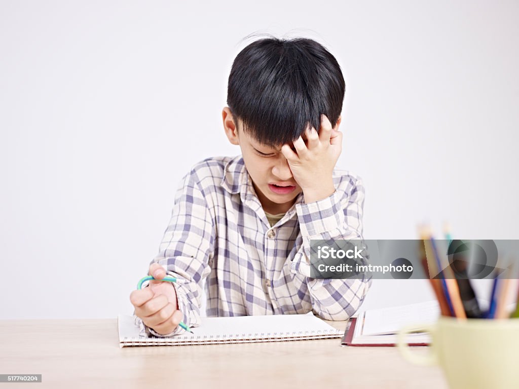 asian child frustrated 10 year-old asian elementary schoolboy appears to be frustrated while doing homework. Child Stock Photo