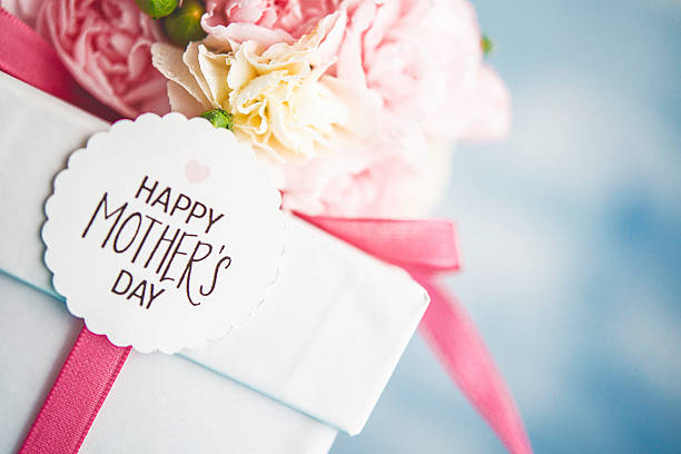 Mother's Day arrangement with pastel flower bouquet and gift Mother's Day arrangement with pastel flower bouquet and gift gift tag note photos stock pictures, royalty-free photos & images