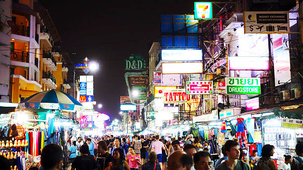 Khao San Road at Night Khao San Road in Bangkok at night: You see many tourists walking around, having fun and enjoying their vacation bangkok street stock pictures, royalty-free photos & images