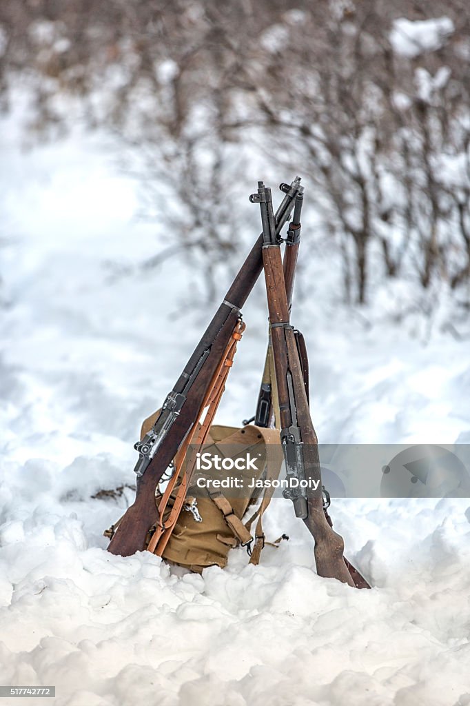 WW II: Front Lines in the Snow M1 Garand Stack Stock photo of three M1 Garand rifles stacked in a swivel in the snowy forrest. 2000 Stock Photo