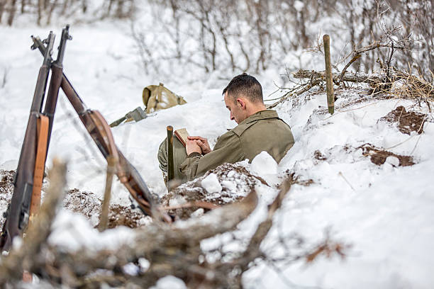 istock WW II: Front Lines in the Snow Bible and Rifles 517743524