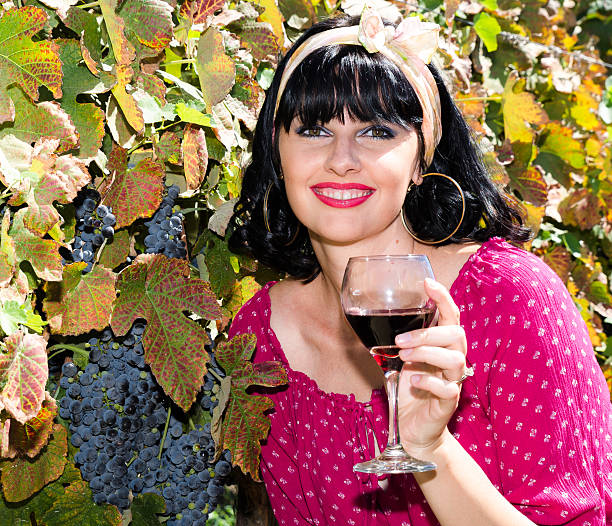 Beautiful woman in colorful dress during grapes harvest
