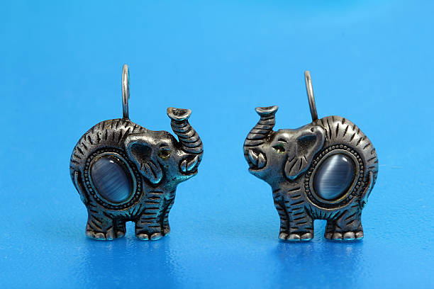 earrings in the shape of elephants that are made of silver