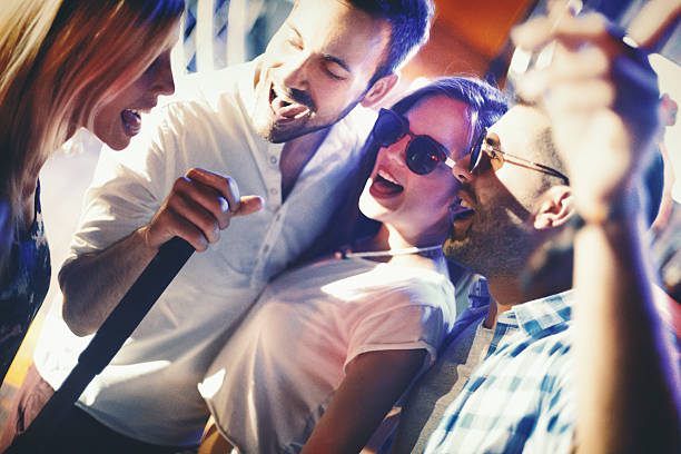 istock Group of people singing karaoke. 517745890