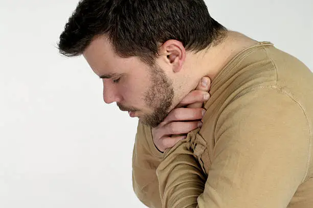 first aid - young man choking over a white background