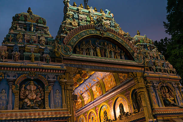 Meenakshi Temple Part of illuminated entrance in the Meenakshi Temple in Madurai, India. Night time.  menakshi stock pictures, royalty-free photos & images