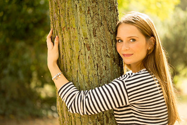istock Woman in autumn hugs a tree 517746317