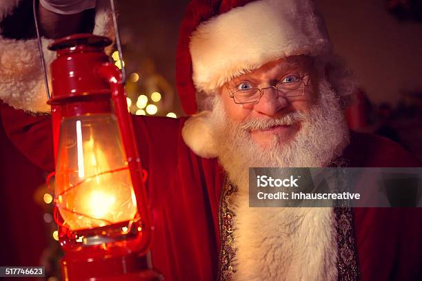 Real Santa Claus Carrying Lantern Stock Photo - Download Image Now - 60-69 Years, Christmas, Color Image