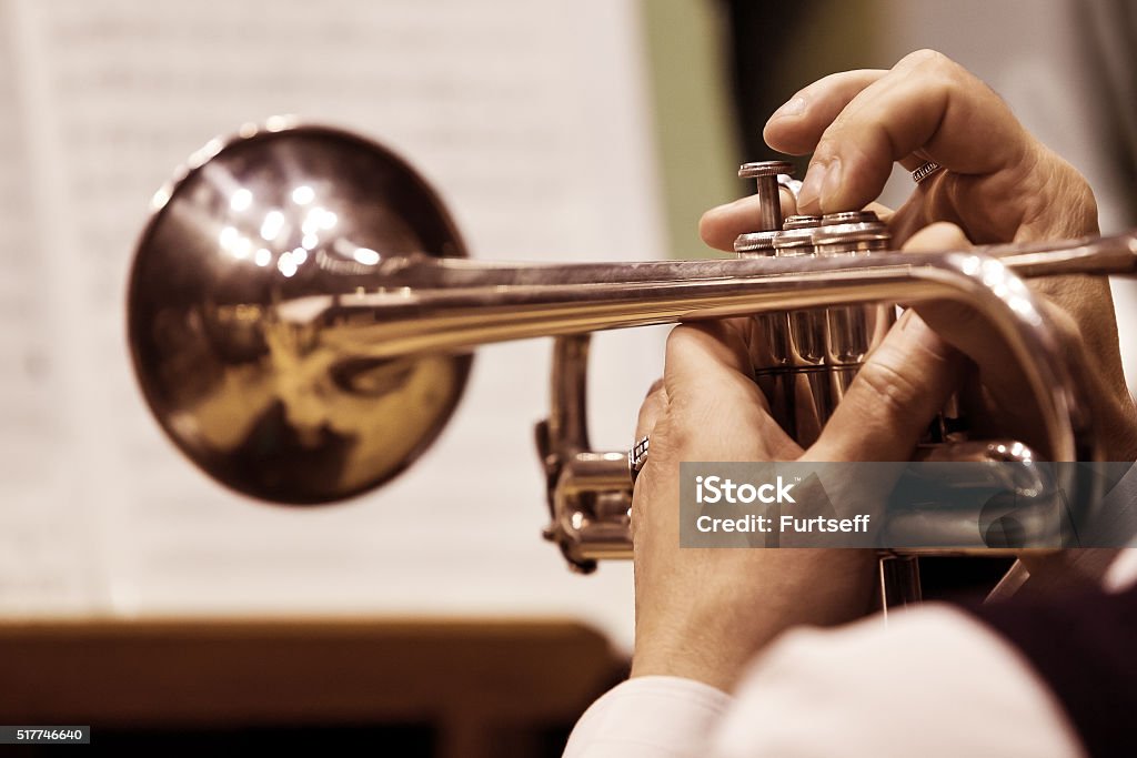 Pipe in the hands of the musician The pipe in the hands of the musician closeup Trumpet Stock Photo