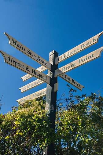 A road sign at a street corner in Nantucket points the way to nearby beaches, roads and services.