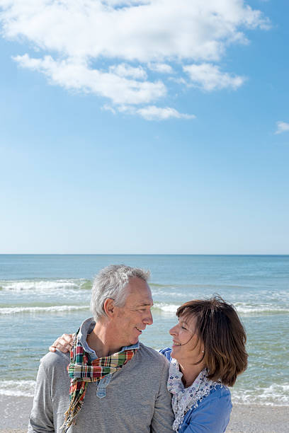 istock Affectionate senior couple in summer on beach 517746917