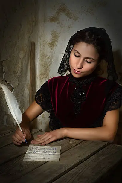 Fine art portrait of a victorian woman writing a letter