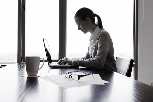 Businesswoman using laptop computer in the office.