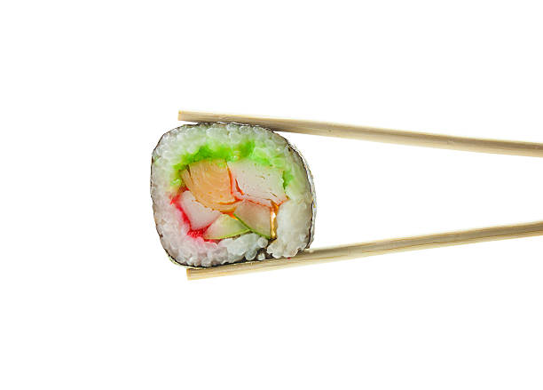 istock Sushi maki in chopsticks isolated on white background 517750406