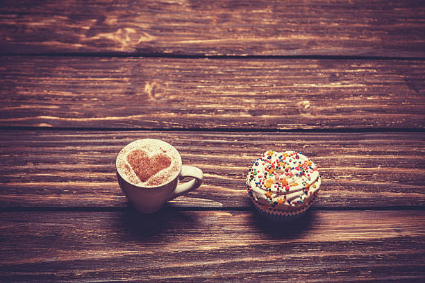 istock Cup of coffee with heart shape on a wooden table. 517751147