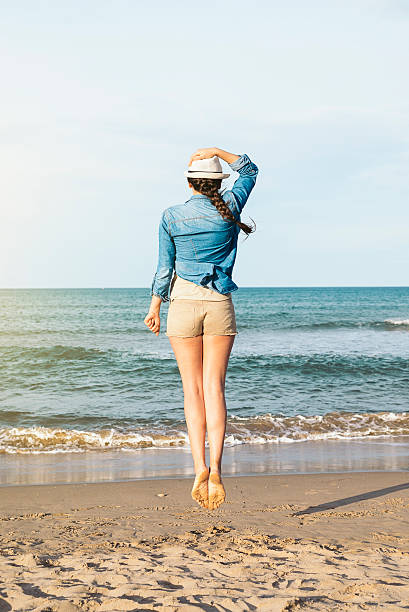 istock Woman jumping on the beach. 517751522