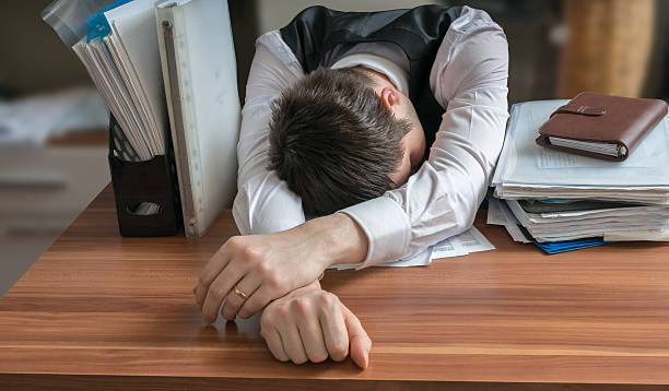 istock Tired workaholic is sleeping on desk in office. 517751842