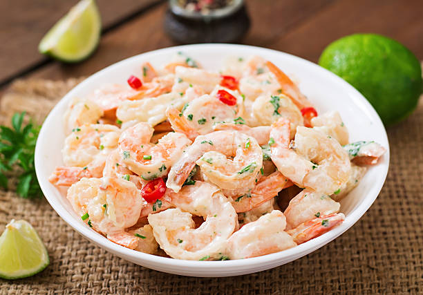 Shrimp in a creamy garlic sauce with parsley stock photo
