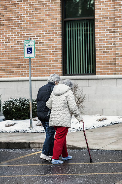 istock Caregiver Daughter Helping Elderly Mother Into Doctor's Office 517776203