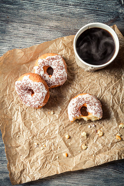 istock Hot coffee and donuts on paper 517777367