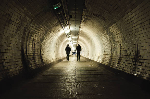 istock Two people walking in the tunnel 517778331