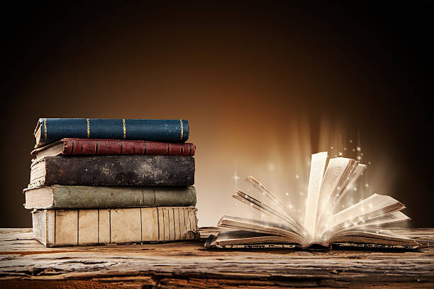 istock Old books on wooden table 517778585