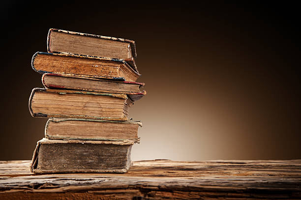 istock Old books on wooden table 517778589
