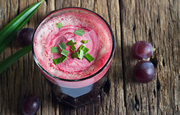 istock Grape smoothie and herb on wooden table background 517779305