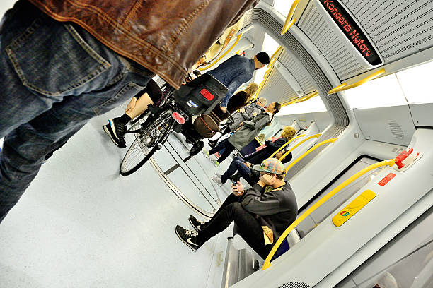 Copenhagen, Denmark - September 14, 2014: Danish commuters in the new Metro (subway). Passengers travelling in  subway train carriage. Typical yellow colors, clean and neat.