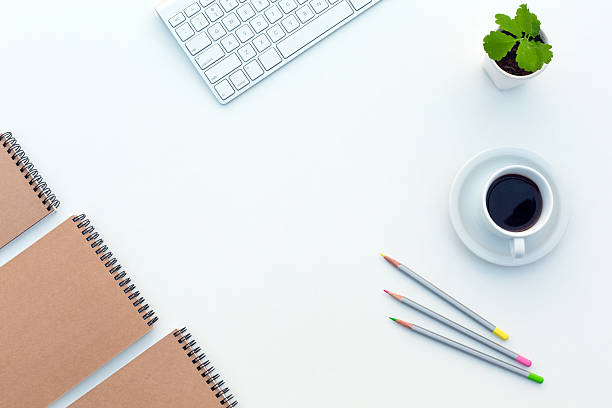 istock White working Desk with Business Items Coffee and Sketch Books 517796580