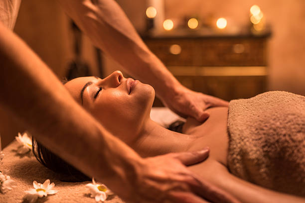 istock Woman relaxing with eyes closed during shoulder massage at spa. 517797210