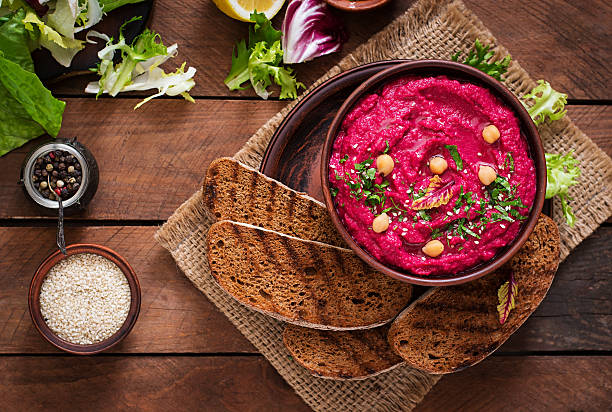 istock Roasted Beet Hummus with toast in a ceramic bowl 517797326