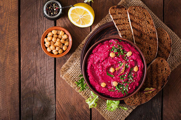 istock Roasted Beet Hummus with toast in a ceramic bowl 517797556