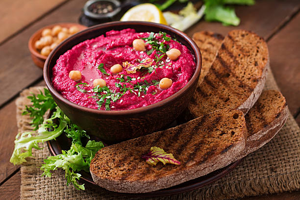 istock Roasted Beet Hummus with toast in a ceramic bowl 517797666