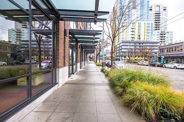 Photo of empty pavement front of modern buildings in seattle