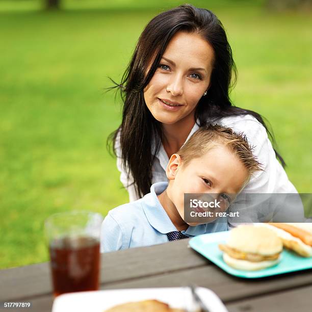 Mom And Son Hugging At Picnic Table Stock Photo - Download Image Now - Adult, Barbecue - Meal, Bonding