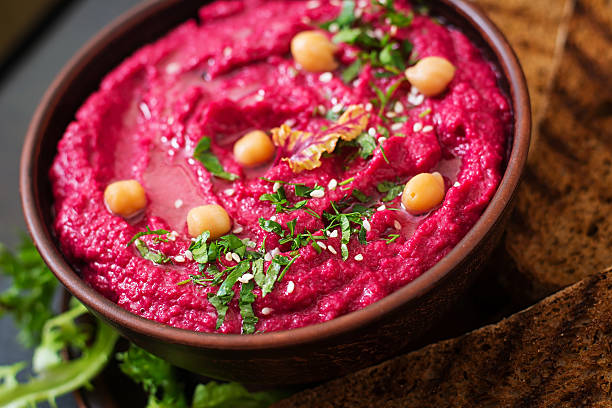 istock Roasted Beet Hummus with toast in a ceramic bowl 517797884