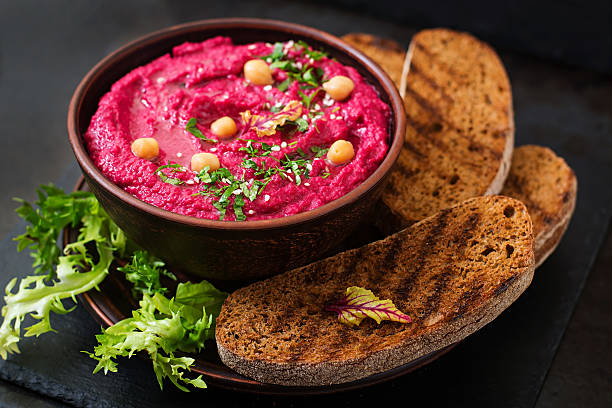istock Roasted Beet Hummus with toast in a ceramic bowl 517797930
