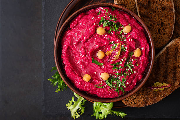 istock Roasted Beet Hummus with toast in a ceramic bowl 517798108