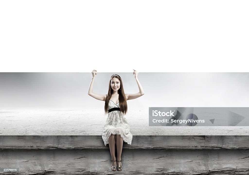 Girl with banner Young asian woman sitting on bench with blank banner Adult Stock Photo