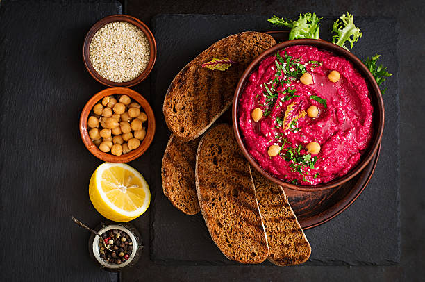 istock Roasted Beet Hummus with toast in a ceramic bowl 517798162
