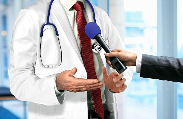 Doctor Talking to Microphone stock photo