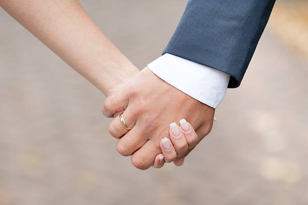 istock male and female hands together 517798656