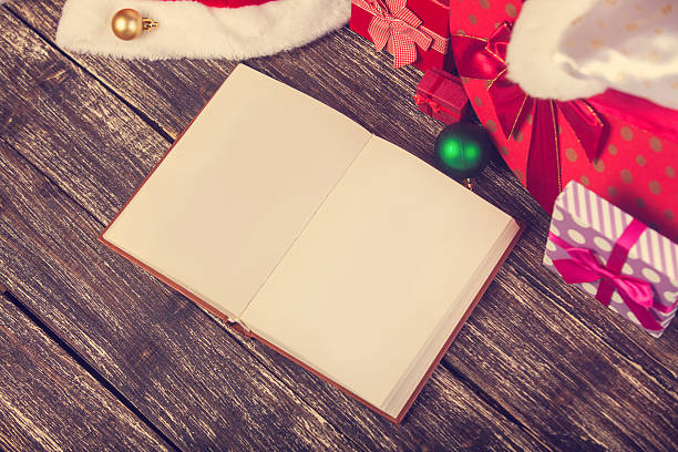 istock Opened book and christmas gifts. 517798779
