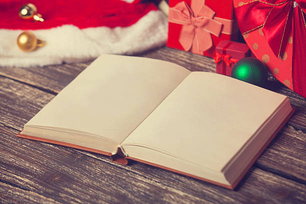 istock Opened book and christmas gifts. 517798781