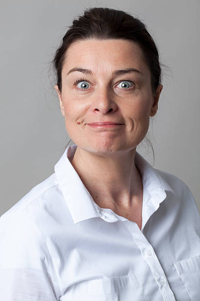 istock joyous smart mature woman smiling, looking with eyes wide open 517800650